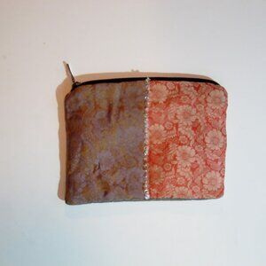 Cloth clutch purse with two color designs.
